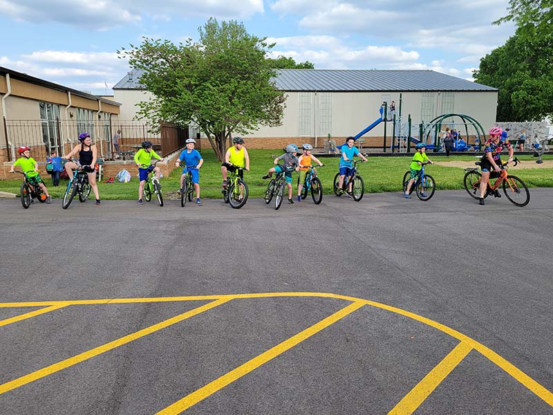 kids triathlon group on bikes with instructor